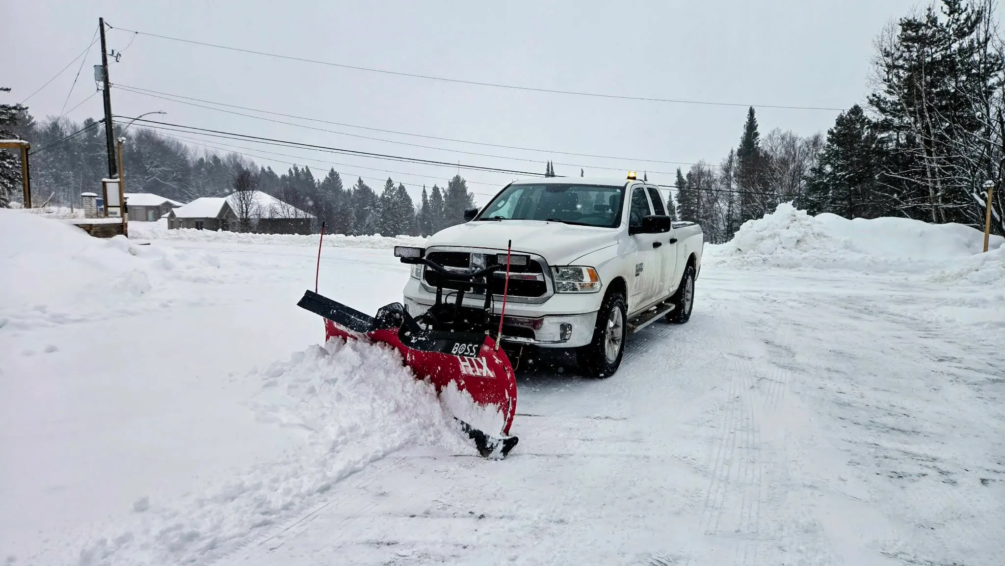 Martin Services plow truck clearing a snowy road in Northern Ontario winter conditions