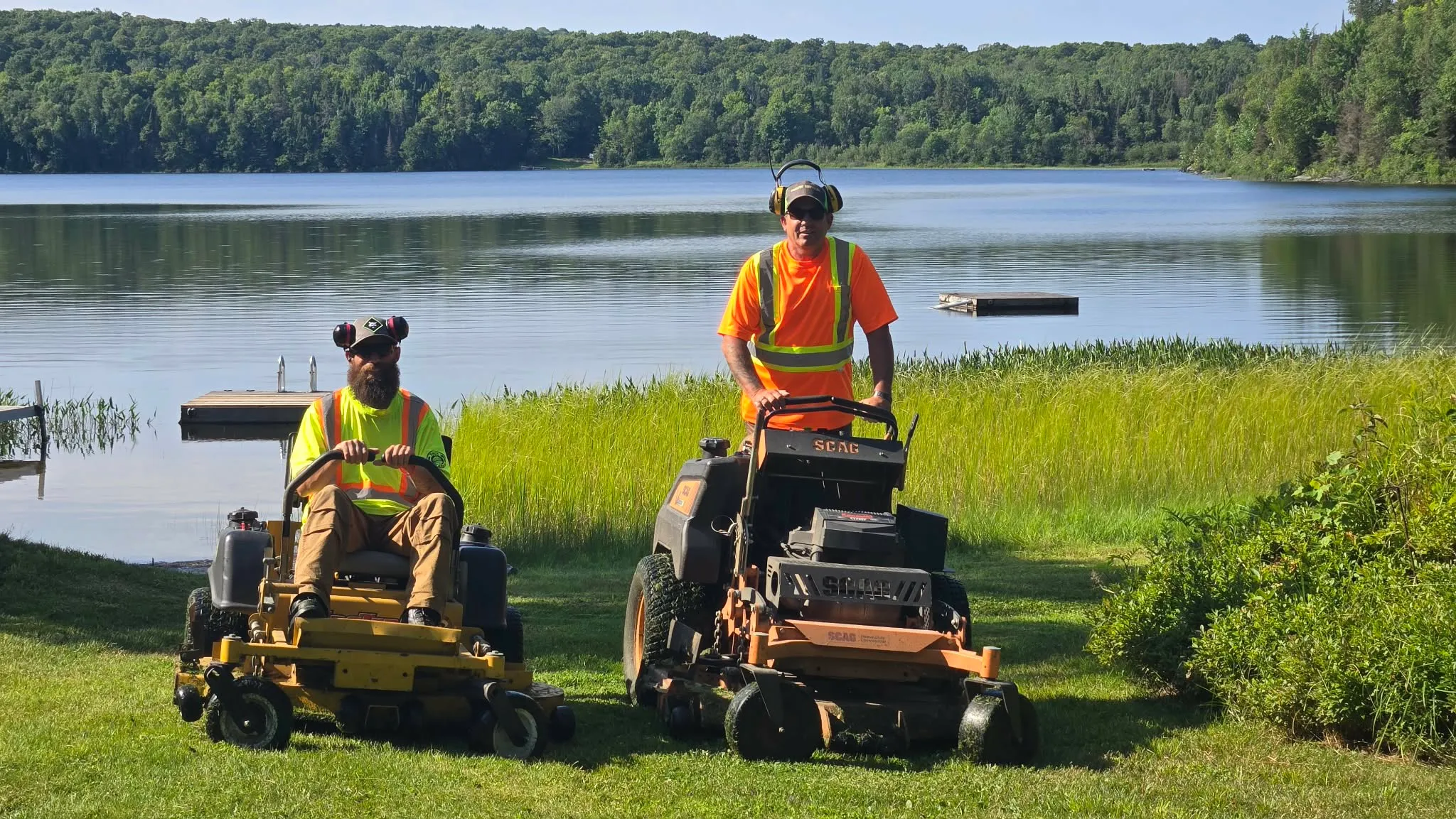 Martin Services crew on commercial mowers maintaining a lakefront property in Northern Ontario