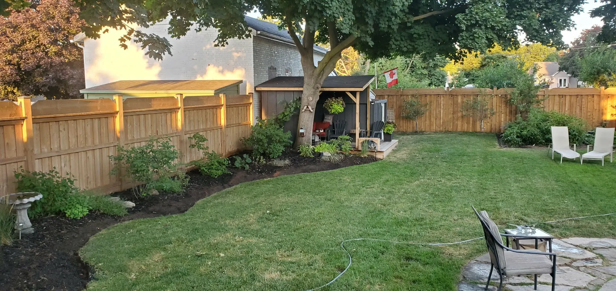 Professional landscaping by Martin Services — beautifully maintained backyard at dusk