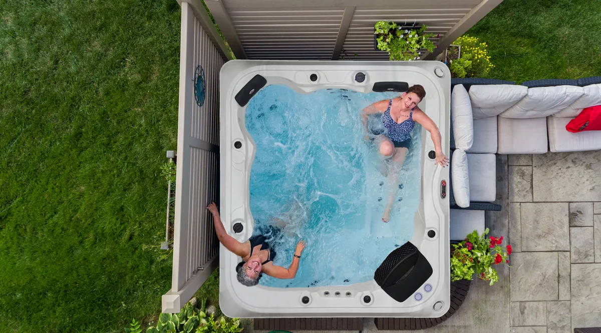 Couple relaxing in hot tub — overhead aerial view of Great Lakes Spa in Northern Ontario