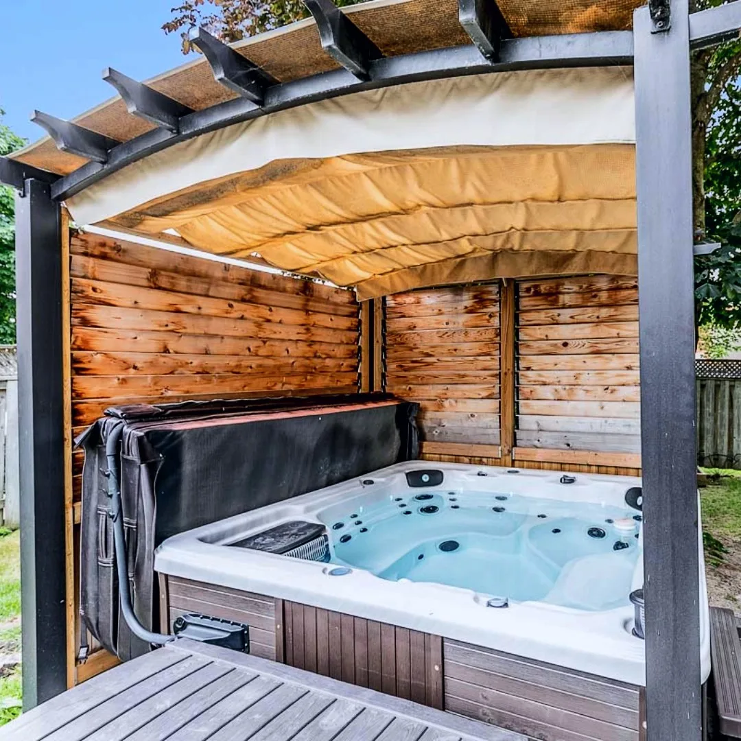 Hot tub installed under pergola canopy — backyard hot tub setup in Powassan, North Bay, Ontario